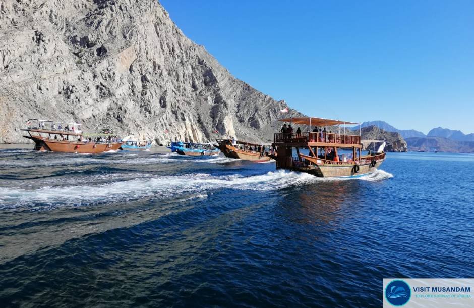 Why is dhow cruising a must-try experience in Musandam?