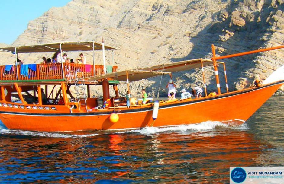 Why is dhow cruising popular among Musandam visitors?